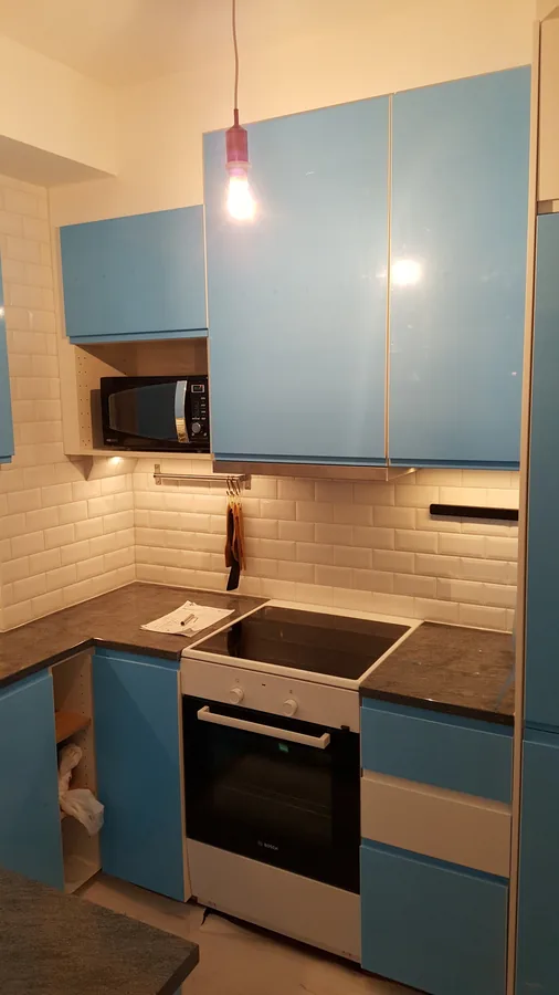 Kök med turkosa luckor och träbänkskiva
